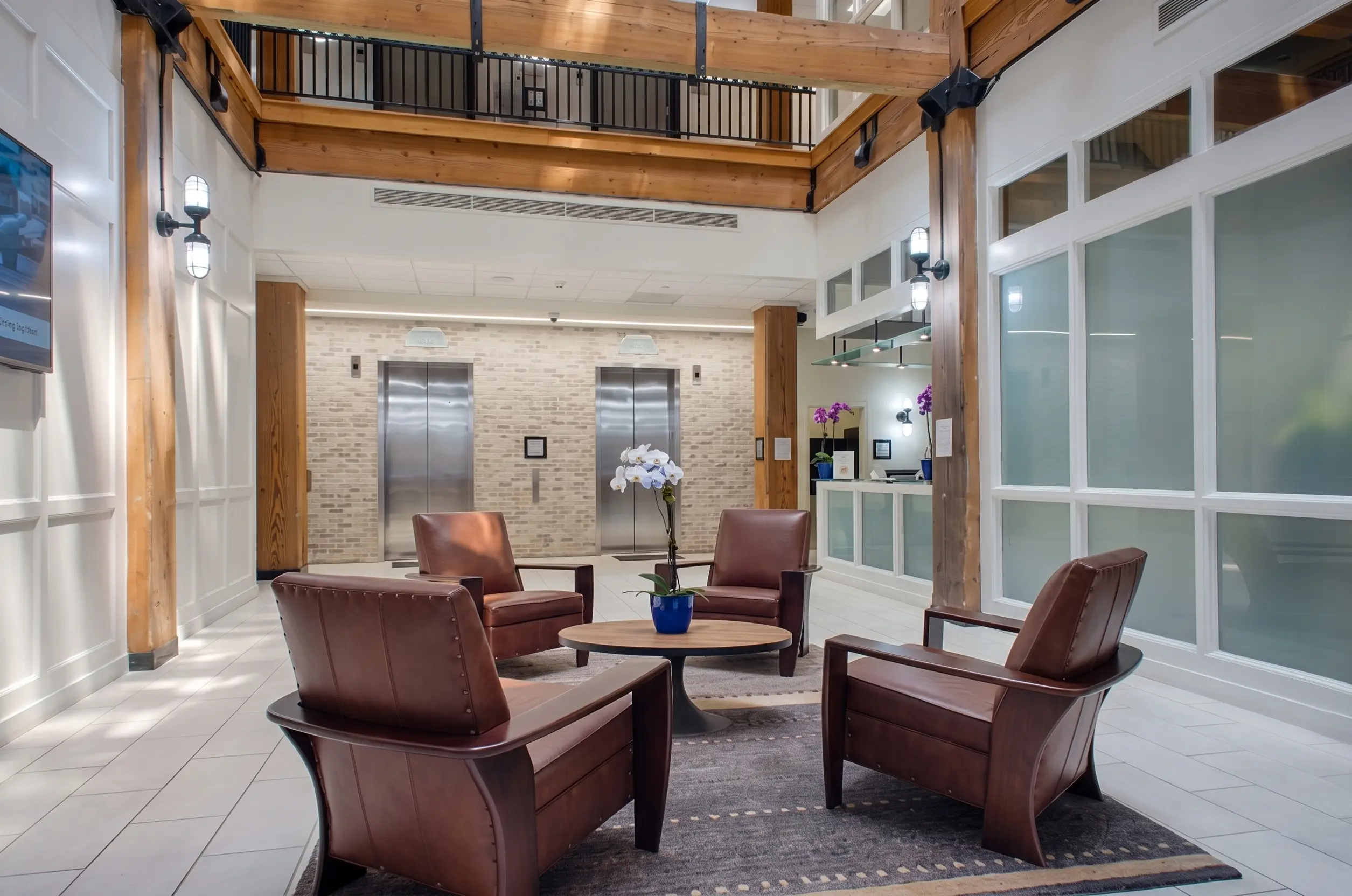modern-commercial-office-lobby-interior-seating-elevators-wood-beams