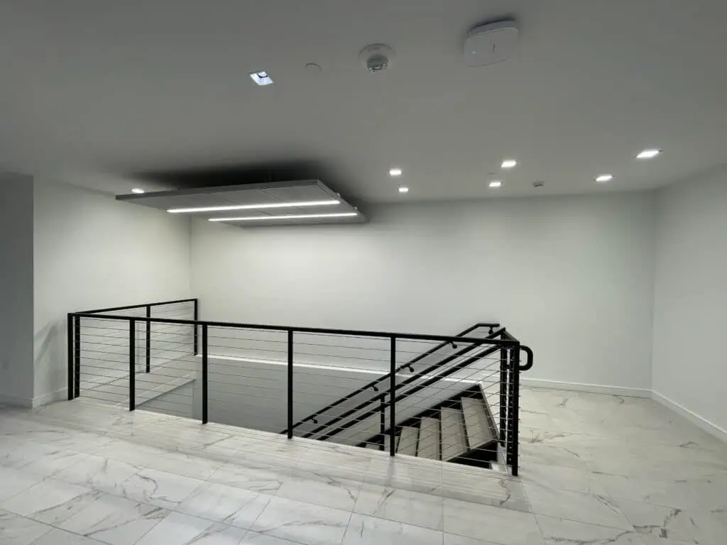 stair-cut-through-office-expansion-denver-class-A-office-building-lighting.webp